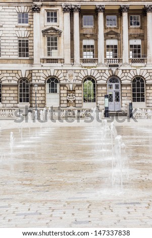 Somerset House - large Neoclassical building (design Sir William Chambers, 1776) in central London, overlooking River Thames. Fountains. Somerset House - one of major art and culture center in London.