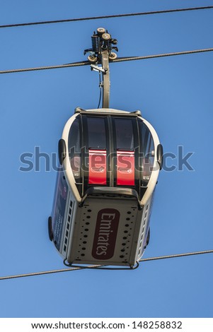 LONDON, UK - MAY 30: View of Emirates Air Line (or Thames cable car) - cable car link Greenwich Peninsula and Royal Dock across River Thames, on May 30, 2013 in London. Service opened on June 2012.