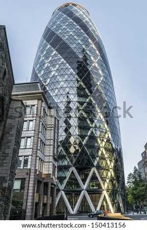 LONDON - JUNE 3: View of Gherkin building (30 St Mary Axe) at sunset in London on June 3, 2013. Gherkin - iconic symbol of London, one of city\'s most widely recognized examples of modern architecture.
