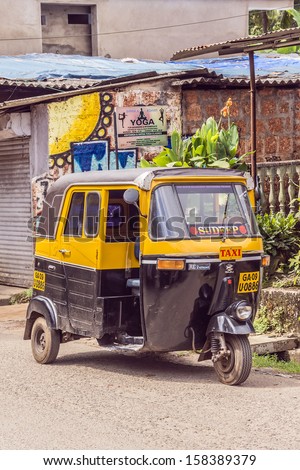 CAVELOSSIM BEACH, GOA, INDIA - SEPTEMBER 22, 2013: Auto rickshaw (tuk-tuk) taxis on a road. Auto rickshaws running on natural gas in an effort to reduce pollution.