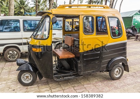 CAVELOSSIM BEACH, GOA, INDIA - SEPTEMBER 22, 2013: Auto rickshaw (tuk-tuk) taxis on a road. Auto rickshaws running on natural gas in an effort to reduce pollution.