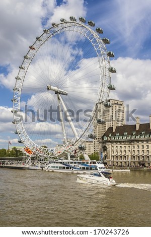LONDON, UK - MAY 25, 2013: View of the London Eye. London Eye (135 m tall, diameter of 120 m) - a famous tourist attraction over river Thames in the capital city London.