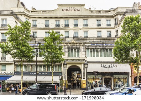 PARIS, FRANCE - SEPTEMBER 14, 2013: Passage Jouffroy (architects Francois Destailleur and Romain de Bourges, 1845) - shopping area with clothing stores, book stores, jewelers shops, confectionery.