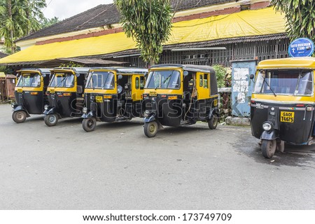 PANJIM, GOA, INDIA - SEPTEMBER 30, 2013: Auto rickshaw (tuk-tuk) taxis on a road. Auto rickshaws running on natural gas in an effort to reduce pollution.