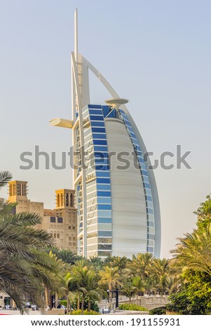 DUBAI, UAE - SEPTEMBER 29, 2012: View of Burj al Arab hotel (7 stars, 1999) from territory of Madinat Jumeirah hotel at sunset. Madinat Jumeirah - luxury 5 stars hotel. United Arab Emirates.