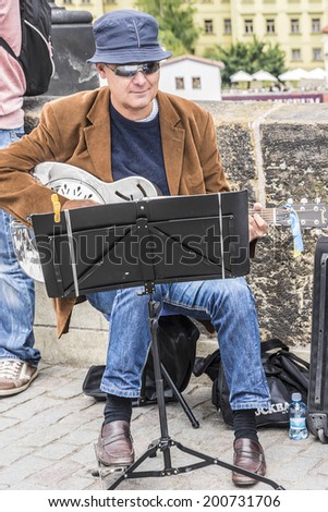 PRAGUE, CZECH REPUBLIC - JUNE 20, 2014: Unknown street musicians on Charles Bridge. Charles Bridge is a popular tourist attraction in Prague. On the bridge you can find many street musicians.