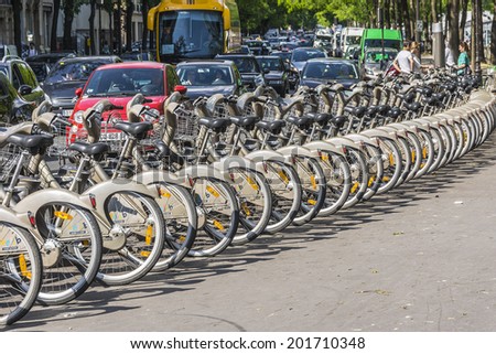 PARIS, FRANCE - MAY 18, 2014: Velib bicycles in the row on Parisian street. Velib is a large-scale public bicycle rental system in Paris.