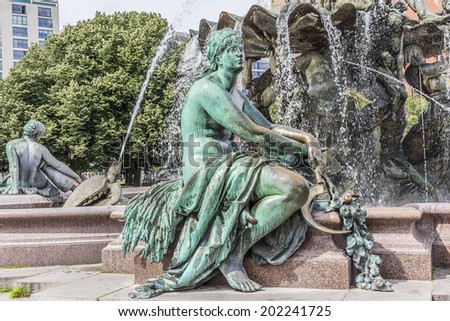 Neptune fountain (Neptunbrunnen, design Reinhold Begas, 1891). Roman god Neptune in center. Four women around him represent the four main rivers of Prussia: Elbe, Rhine, Vistula and Oder.