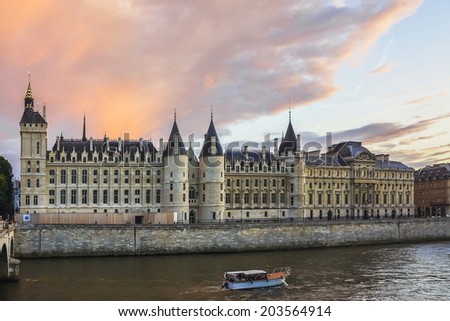 Conciergerie Castle on a background of purple sunset. Conciergerie is a former royal palace and prison in Paris. Today it is part of the larger complex known as the Palais de Justice. France, Europe