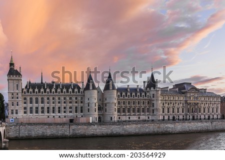 Conciergerie Castle on a background of purple sunset. Conciergerie is a former royal palace and prison in Paris. Today it is part of the larger complex known as the Palais de Justice. France, Europe