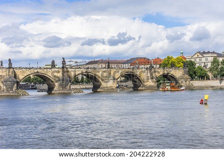 View of Charles Bridge (Karluv most, 1357), a famous historic bridge that crosses the Vltava River in Prague, Czech Republic. Bridge is decorated by 30 statues, originally erected around 1700.