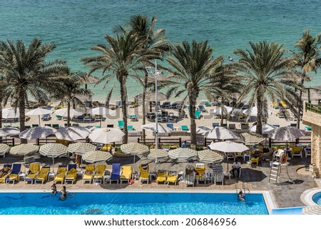 SHARJAH, UAE - SEPTEMBER 25, 2012: Sea, beach at 4-star Carlton Hotel in Sharjah. Hotel is sited on the shores of Al Khan beach. Resort features 173 guest rooms and chalets. United Arab Emirates.