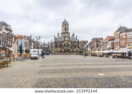DELFT, NETHERLANDS - JUNE 17, 2014: Old houses, stores and restaurant on the Markt (central square) of Delft, Holland.