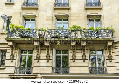 Old French house with traditional balconies and windows. Paris, France.