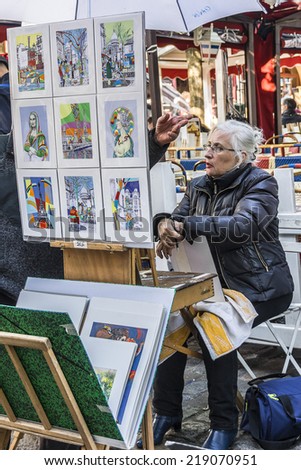 PARIS, FRANCE - MAY 15, 2014: Artists easels and artwork set up in Place du Tertre in Montmartre. Montmartre attracted many famous modern painters in the early 20th century.