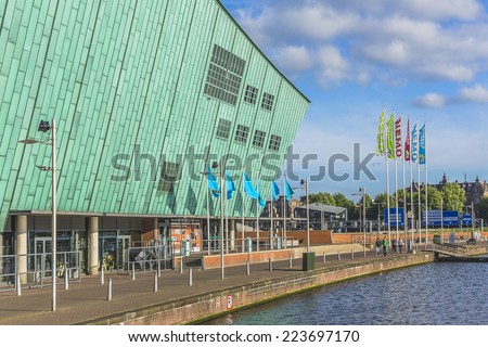 AMSTERDAM, NETHERLANDS - JUNE 17, 2014: Science Center NEMO designed by Renzo Piano (1997) - largest children\'s science educational museum, knowledge institute and center of tourism in Netherlands.