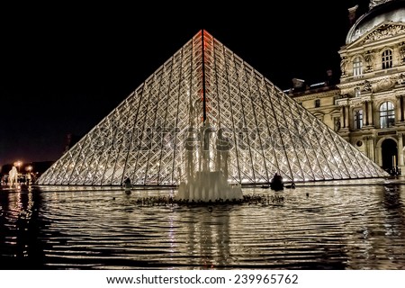 PARIS, FRANCE - NOVEMBER 12, 2014: Night view of famous pyramid in Louvre Museum courtyard. Louvre Museum is one of the largest and most visited museums worldwide.