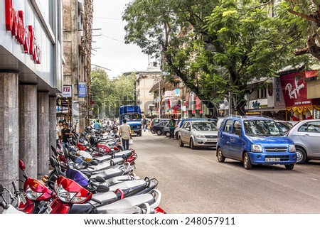 PANJIM, GOA, INDIA - SEPTEMBER 30, 2013: Street views of the capital of the Goa state: old houses and traffic. Panjim (Panaji) - capital of Indian state of Goa and Goa\'s largest city.