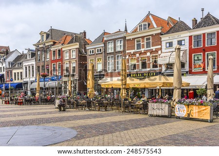 DELFT, THE NETHERLANDS - JUNE 17, 2014: City landscape of Markt (central square). Delft - beautifully preserved historic city - from a rural village in the early Middle Ages Delft developed to a city.