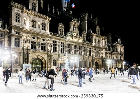 PARIS, FRANCE - DECEMBER 22, 2014: Skating near Hotel de Ville (City Hall, 1874 -1882, architects Theodore Ballou and Edouard Deperta). Building housing City of Paris\'s administration.