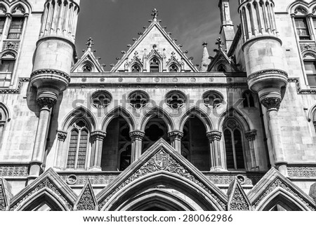Royal Courts of Justice in the Victorian Gothic style (Law Courts, designed by George Edmund Street, was opened by Queen Victoria in December 1882) in London, UK. Black and white.