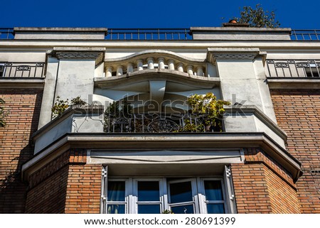 French house with traditional balconies and windows. Paris, France.