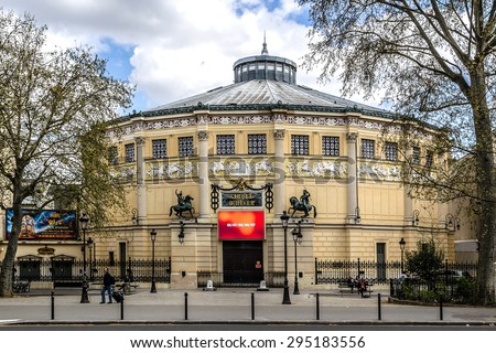 PARIS, FRANCE - APRIL 12, 2015: View of Cirque d\'Hiver (Winter Circus). Theatre was designed by architect Jacques Ignace Hittorff and was opened by Emperor Napoleon III in 1852 as Cirque Napoleon.