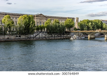 PARIS, FRANCE - MAY 30, 2015: View of famous Louvre Museum from the Seine River. Louvre Museum is one of the largest and most visited museums worldwide.