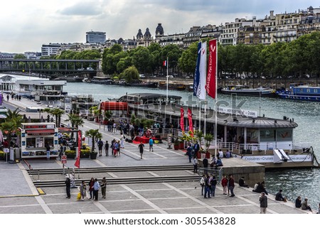 PARIS, FRANCE - JUNE 1, 2015: View of the Seine River with cruise tour boats. In Paris there are several boat tourist trips across the Seine to show tourists the sights of interest.