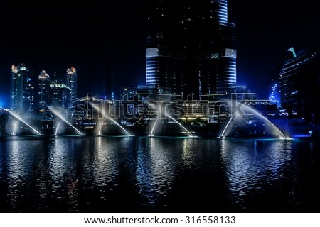 DUBAI, UNITED ARAB EMIRATES - SEPTEMBER 8, 2015: A record-setting fountain system set on Burj Khalifa Lake - 6600 lights and 25 projectors, it shoots water 150 m into the air. UAE.