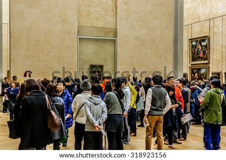 PARIS, FRANCE - DECEMBER 22, 2014: Tourists visit art gallery in Louvre Museum. Louvre Museum is one of the largest and most visited museums worldwide.