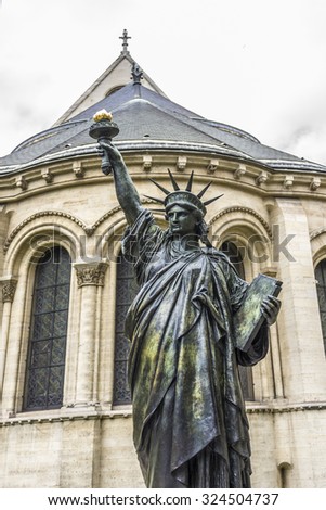 PARIS, FRANCE - JUNE 6, 2015: Museum of Arts and Crafts (1794) houses collection of National Conservatory of Arts and Industry is a museum of technological innovation. Statue of Liberty near entrance.