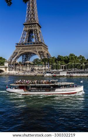 PARIS, FRANCE - JUNE 6, 2015: View of the Seine River with cruise tour boats. In Paris there are several boat tourist trips across the Seine to show tourists the sights of interest.