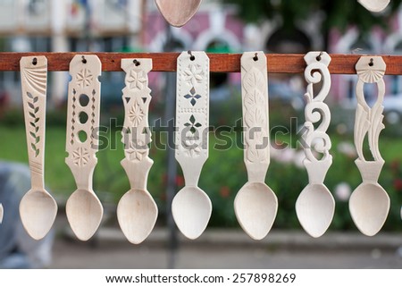 Detail of a variety of sculpted romanian traditional wooden spoons
