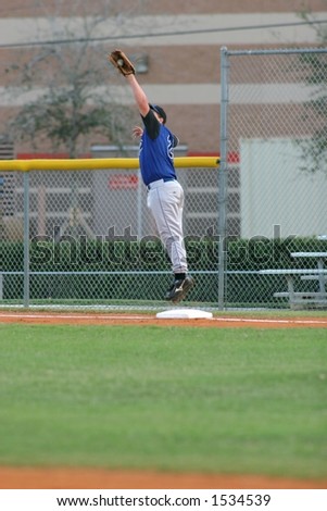 First baseman jumps to catch ball
