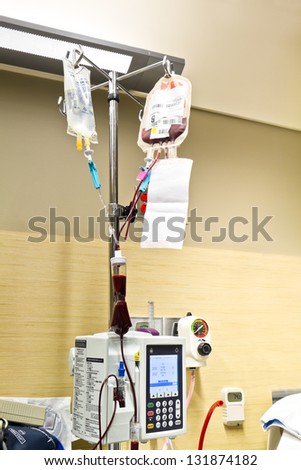 Patient Blood Transfusion and Saline Solution IV in Hospital Room