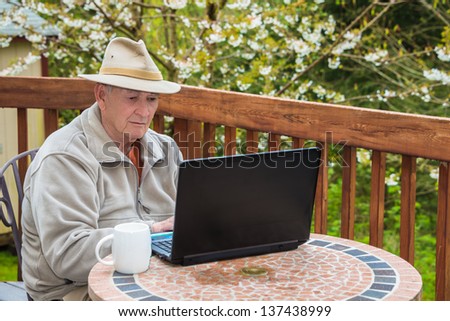 Elderly Man Working on Laptop Computer