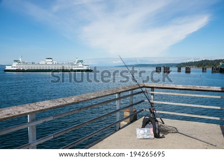 Pier with recreational fishing gear and car ferry.  Copy space.