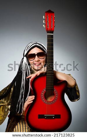 Guitar player with red instrument