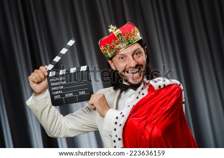 King with movie board in funny concept