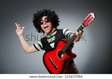 man with funny haircut and guitar