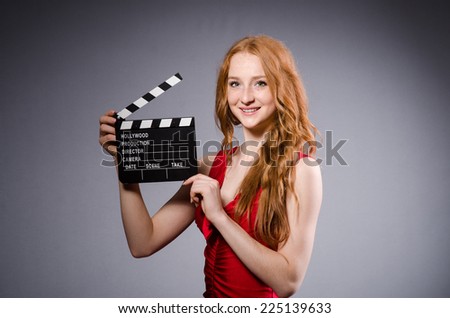 Woman in red dress with movie board
