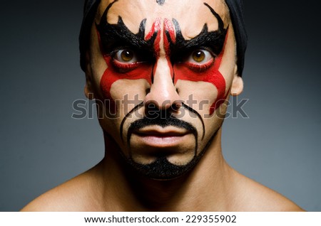 Man with face covered with facepaint