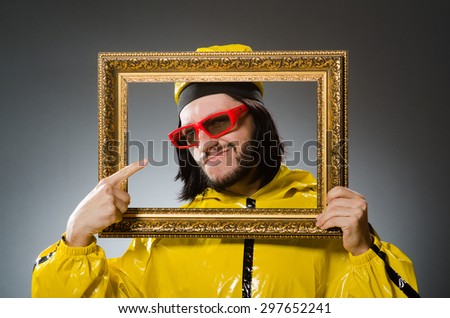 Man wearing yellow suit with picture frame