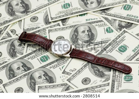 Hand watch over  the hundred dollar bank notes