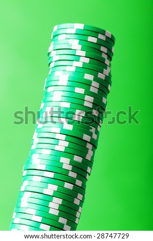 Stack of green casino chips against green background