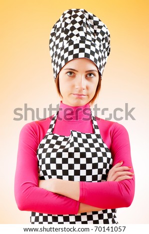 Young female cook against gradient background