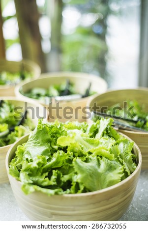 mixed lettuce salad leaves in bowls in restaurant display
