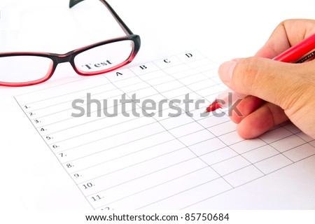 Hand on red pen choosing the test list and glasses on the examination