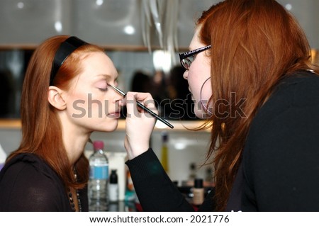 Make up artist making up model backstage